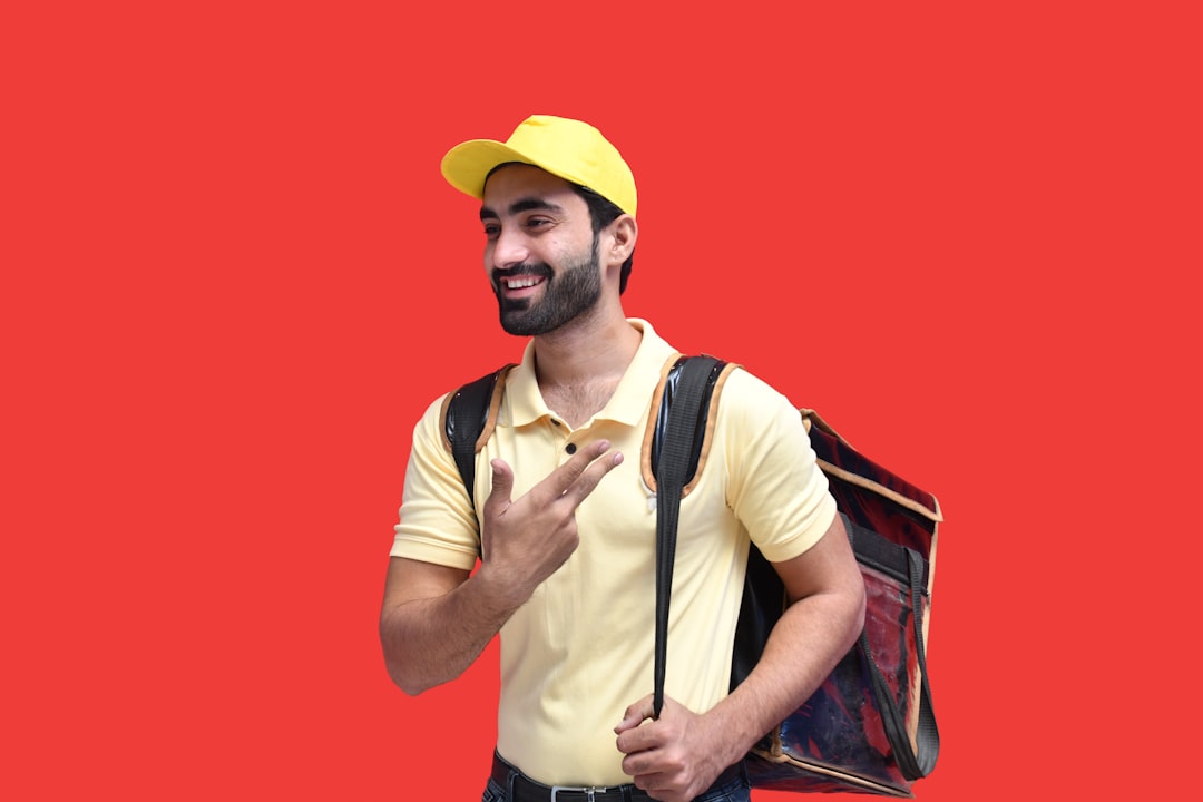 a man with a beard and a yellow hat with a backpack