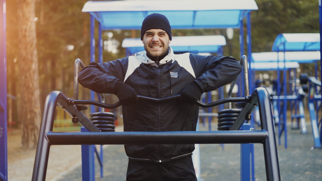 Man exercising on outdoor gym equipment