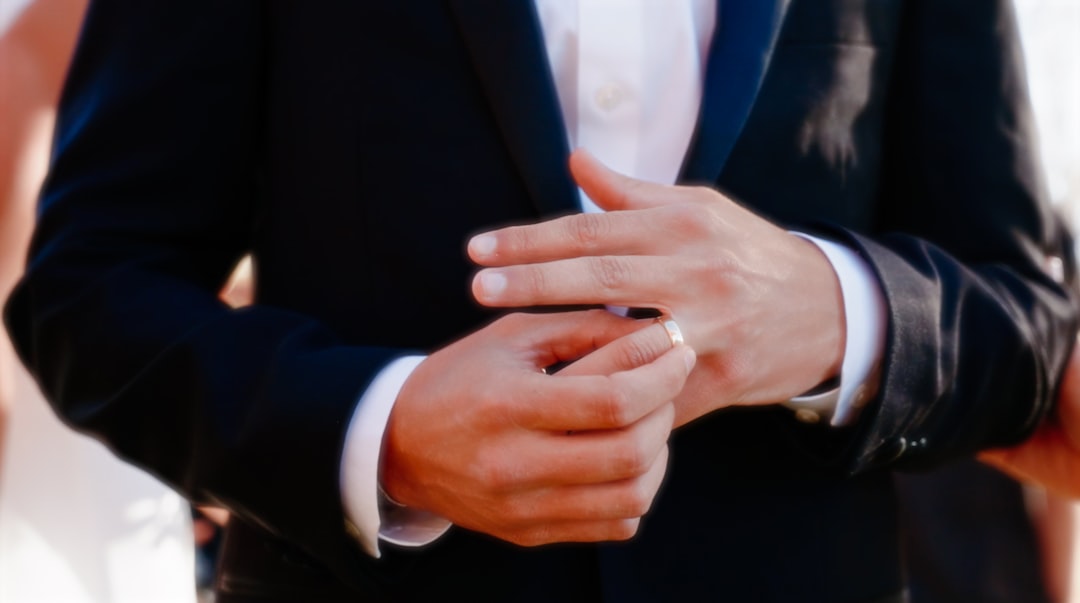 a close up of a person wearing a suit and tie