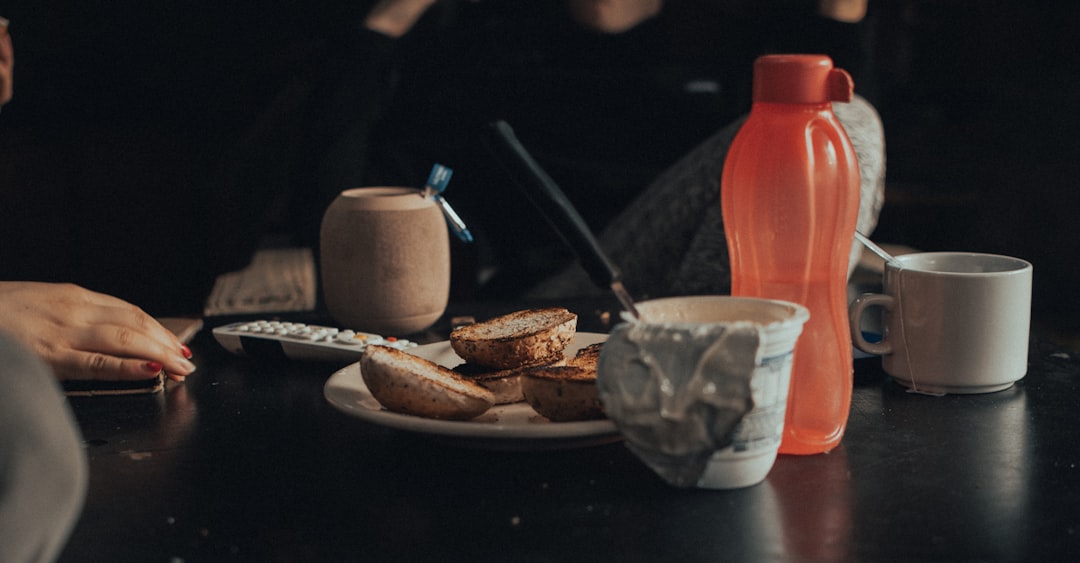 a person sitting at a table with a plate of food